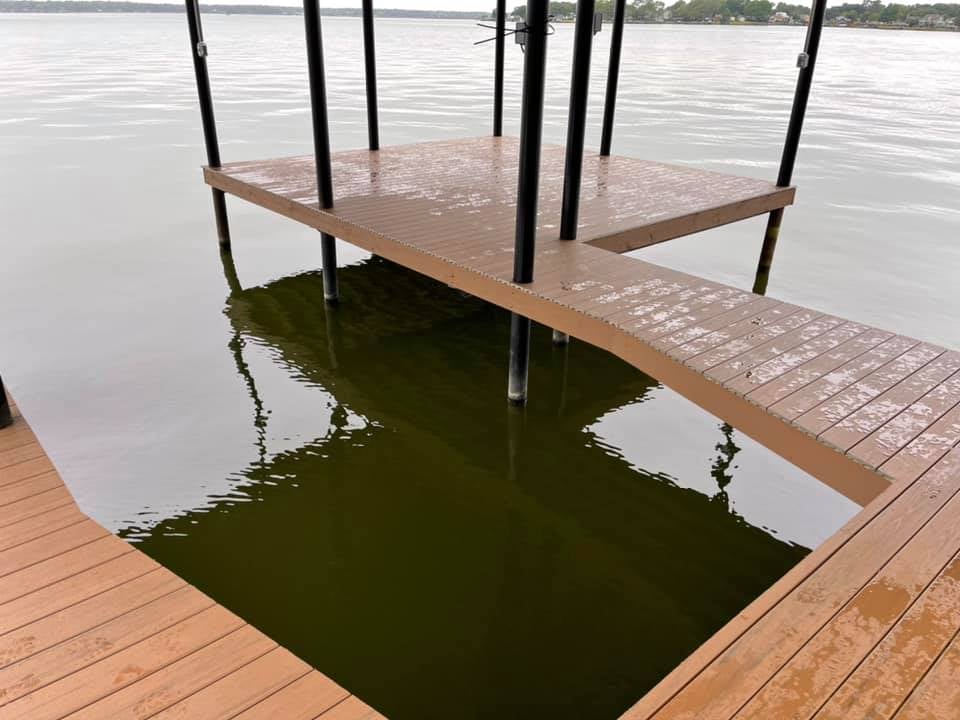 A wet dock in light brown color pictured on the water
