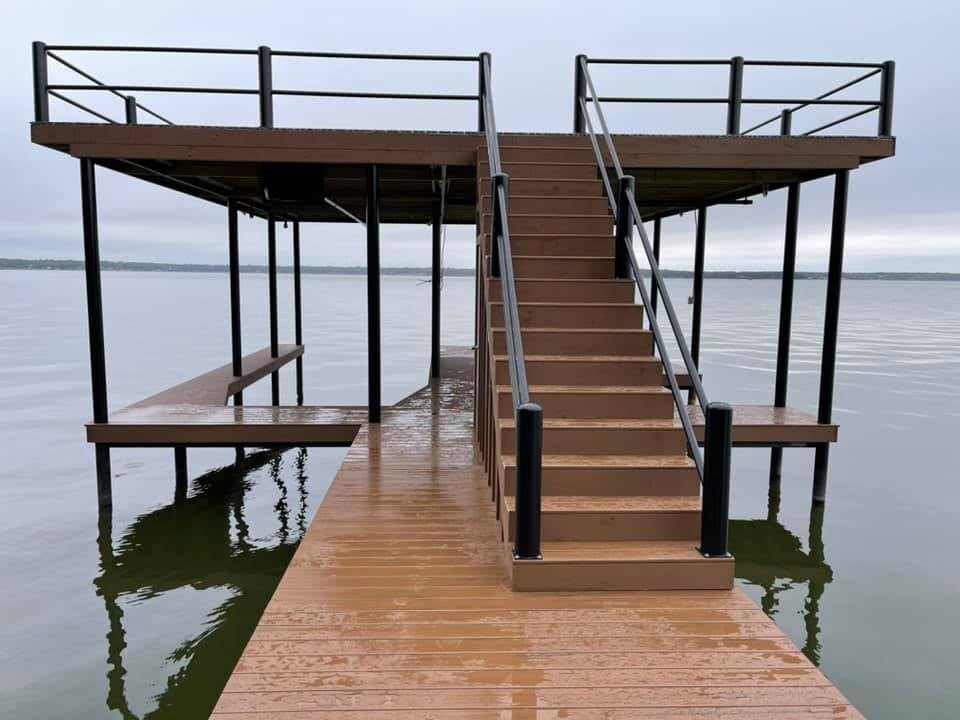 Brown dock pictured on the water with stairs
