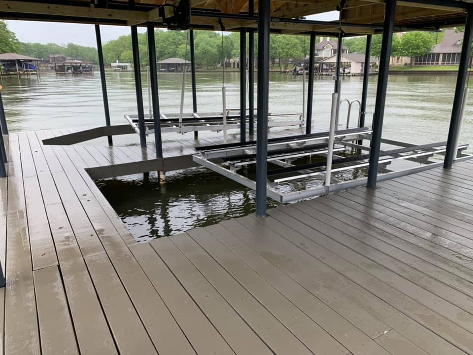 Two boat holders in a custom deck / covered boat house on the water