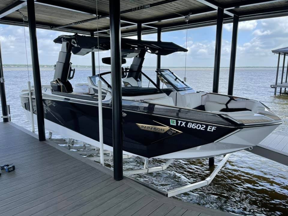 A Paragon sports boat pictured on a boat stand in a boat house/deck
