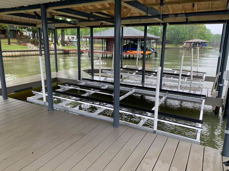 A double boat holding deck on the water no boats pictured