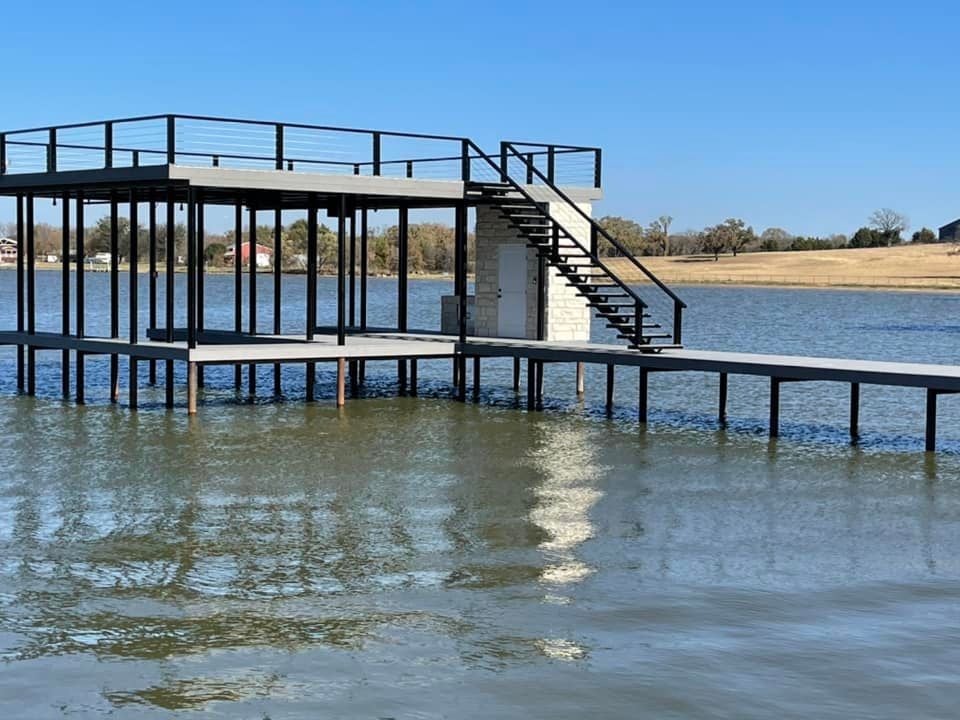 Custom double layered deck with stairs pictured on the water